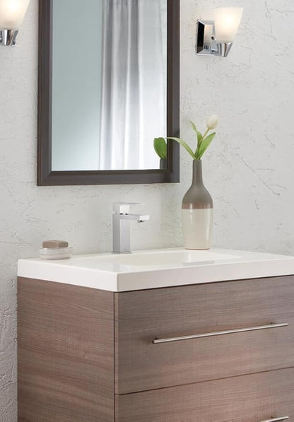 Bathroom vanity with mirror, faucet, and decorative elements.