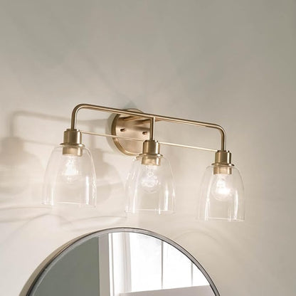 Kichler Meller 24.25 Inch 3 Light Vanity Light with Clear Glass Shades in Champagne Bronze for Bathroom or Powder Room, (24.25" W x 11.25" H x 7" D) 55102CPZ
