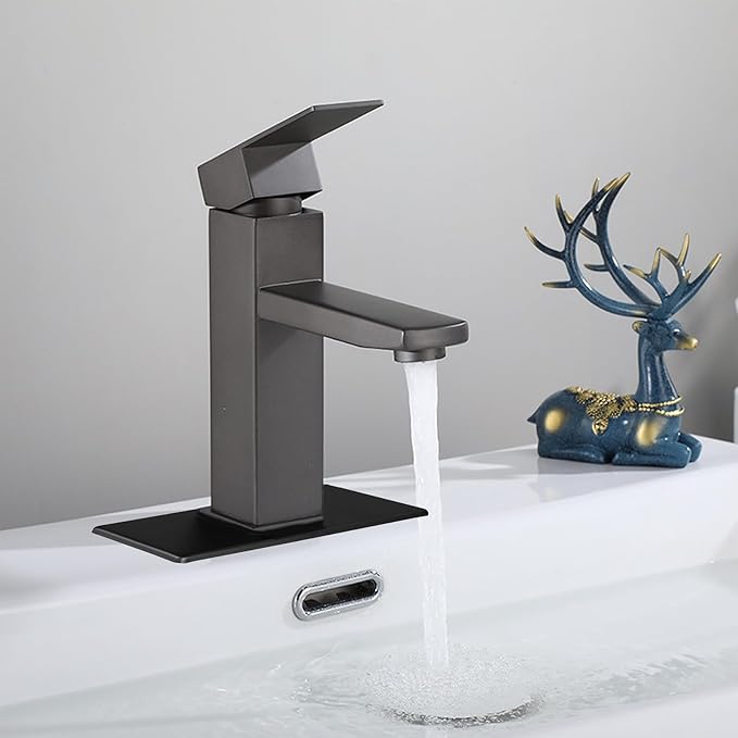 Black faucet with water flowing into a sink, accompanied by a decorative deer figurine on a light gray background.