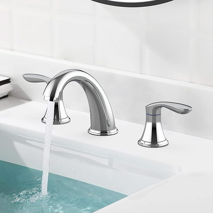 Chrome bathroom faucet with water flowing into a sink.