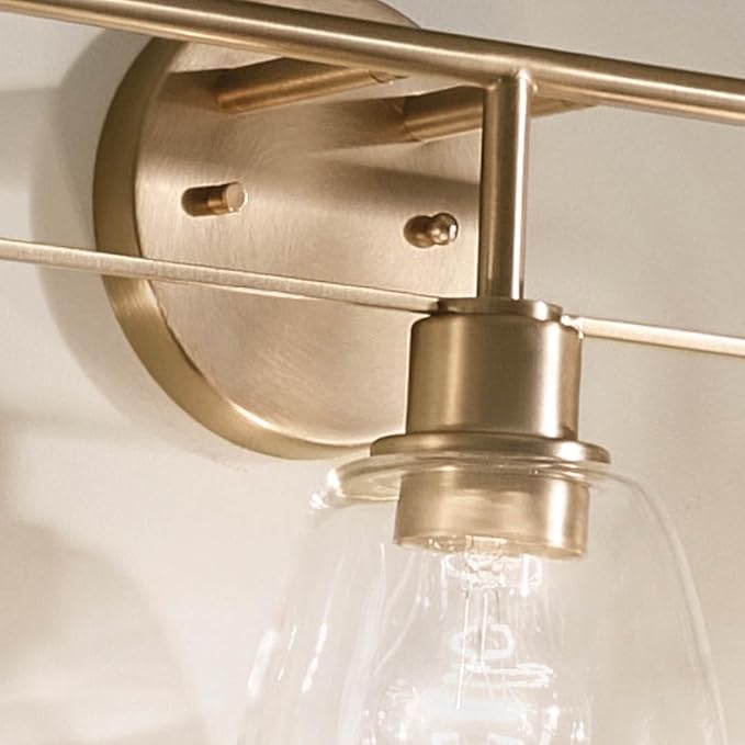 Kichler Meller 24.25 Inch 3 Light Vanity Light with Clear Glass Shades in Champagne Bronze for Bathroom or Powder Room, (24.25" W x 11.25" H x 7" D) 55102CPZ