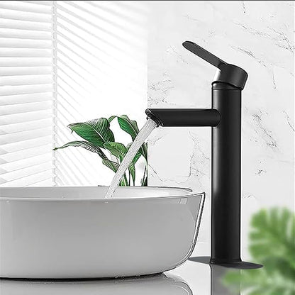 Black faucet with water flowing into a white sink against a light marble wall.