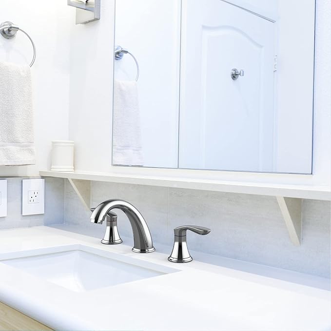 Bathroom sink with faucet and mirror above in a white bathroom.