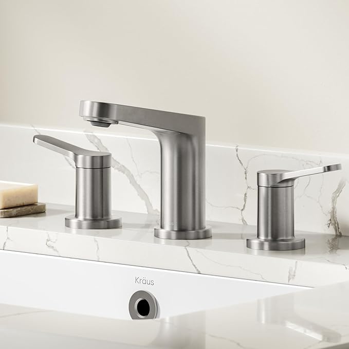 Modern silver faucet set on a marble countertop with a neutral background