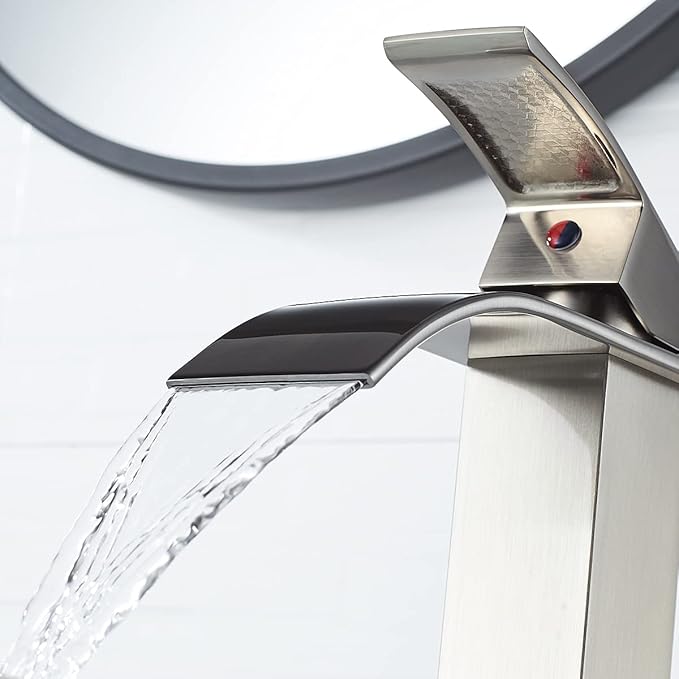 Modern silver faucet with water flowing in a bathroom setting