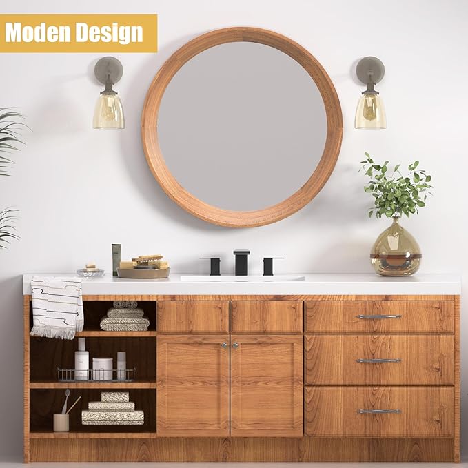 Bathroom vanity with wooden cabinets, round mirror, and decorative items.