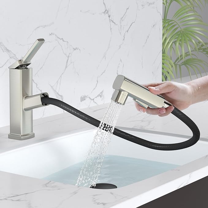 Handheld shower head with flexible hose being held over a sink