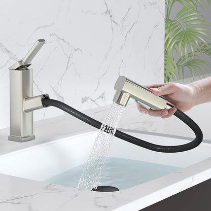 Handheld shower head with flexible hose being held over a sink