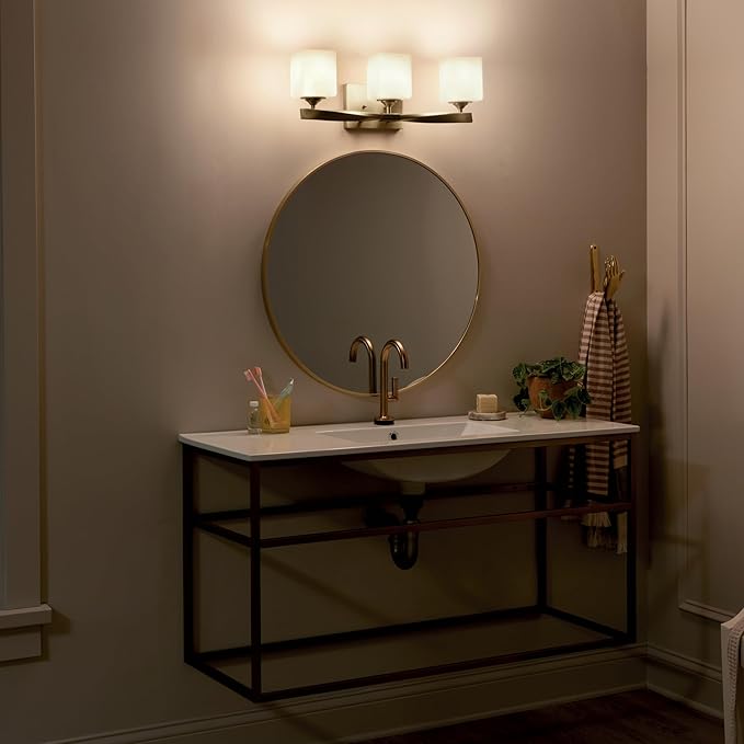 Kichler Marette 23 inch 3 Light Vanity Light with Satin Etched Cased Opal Glass in Champagne Bronze for Bathroom and Powder Room, (23" W x 8.25" H x 6" Ext), 55002CPZ