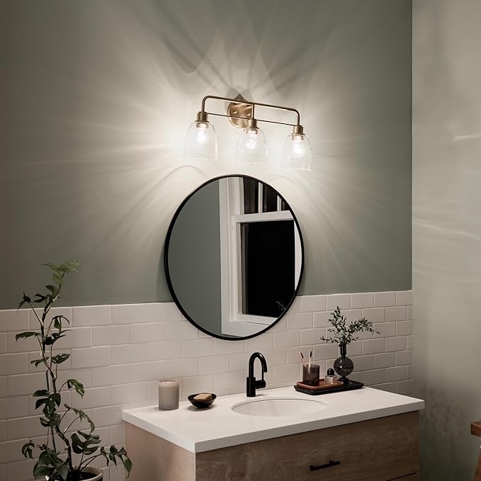 Kichler Meller 24.25 Inch 3 Light Vanity Light with Clear Glass Shades in Champagne Bronze for Bathroom or Powder Room, (24.25" W x 11.25" H x 7" D) 55102CPZ