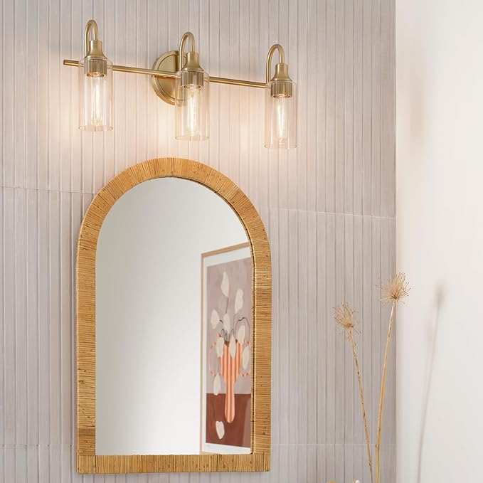 Kichler Kavi 23" 3-Light Vanity Light with Clear Glass in Champagne Bronze, Damp Rated, for Bathroom, Powder Room, Over a Mirror, (23" W x 10" H), 55211CPZ