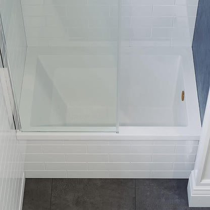 Bathroom with white tiled walls and a glass shower enclosure.