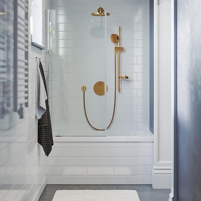 Modern shower setup with gold fixtures in a tiled bathroom.