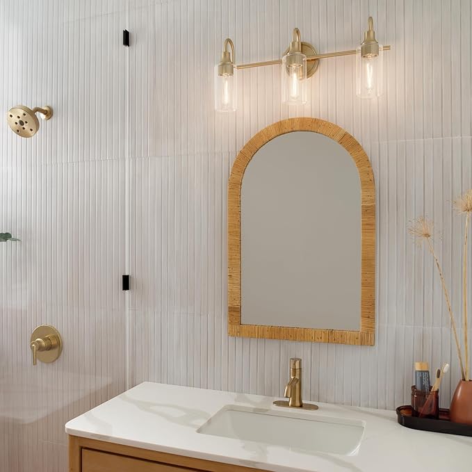 Kichler Kavi 23" 3-Light Vanity Light with Clear Glass in Champagne Bronze, Damp Rated, for Bathroom, Powder Room, Over a Mirror, (23" W x 10" H), 55211CPZ