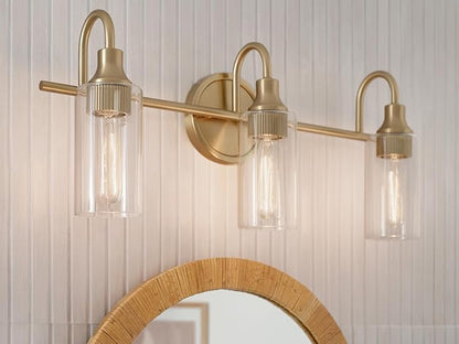 Kichler Kavi 23" 3-Light Vanity Light with Clear Glass in Champagne Bronze, Damp Rated, for Bathroom, Powder Room, Over a Mirror, (23" W x 10" H), 55211CPZ