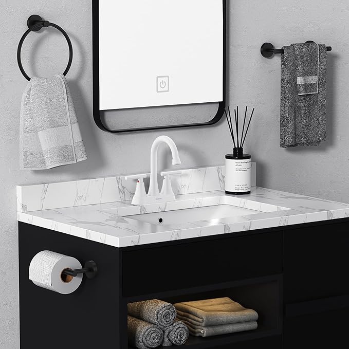 Bathroom vanity with sink, mirror, and towels
