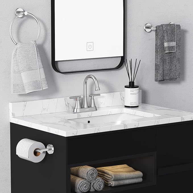 Bathroom vanity with sink, mirror, and towels