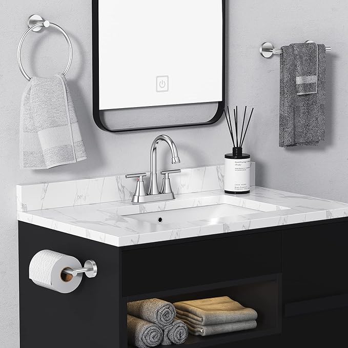 Bathroom vanity with sink, mirror, and towels