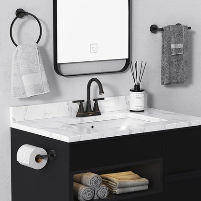 Bathroom vanity with black fixtures, white countertop, and towels.
